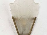 a wall light that is hanging on a white wall