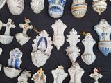 many different vases and figurines displayed on a table