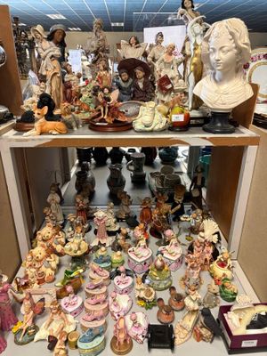 de nombreuses figurines posées sur une étagère dans une pièce
