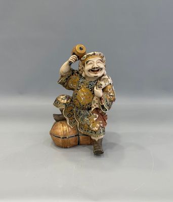 an image of a figurine of a man sitting on top of a ball