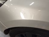 a close up of a car ' s front bumper with a dent on it