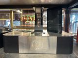 an image of a counter in a restaurant with a sign on it