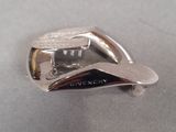 a close up of a silver metal object on a table