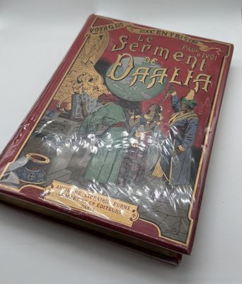 an old book sitting on top of a table covered in plastic