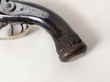 a gun that is sitting on a white surface