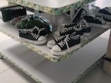 a table with shoes and bags on it in a store