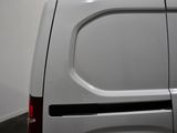 a white van parked in a room with a white wall