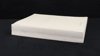 an open book sitting on top of a black table next to a black background