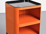 an orange and black side table with two shelves on top of it