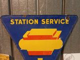 a sign that says station service on the side of a building