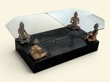a glass table with statues on it and a mirror on the top