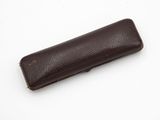 a brown leather case on a white surface