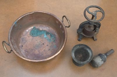 a metal pan with a handle and some other items on a table
