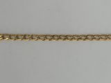 a close up of a gold chain on a white surface