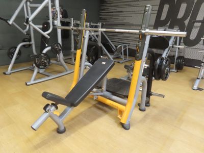 a gym with a bench, weights, and other equipment in the room