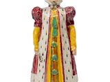 an image of a figurine of a woman in a dress and hat