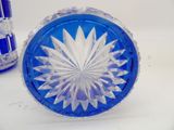 a blue glass bowl with a white flower on it