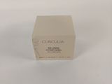 a close up of a box of cream on a white surface