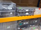 many bins of assorted items on a shelf