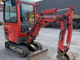an image of a red excavator parked in a parking lot