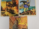 trois livres pour enfants sont posés sur une surface blanche