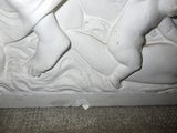 a statue of a baby laying down on a bed