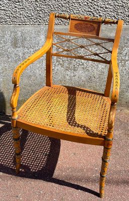 a yellow chair that is sitting in front of a wall