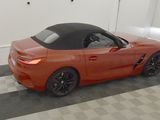 an image of an orange sports car parked in a garage