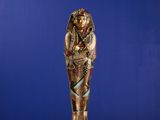 an egyptian statue of a woman holding a baby in her arms