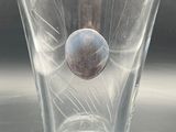 a glass with a ball inside of it on a table