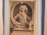 a picture of a man sitting at a desk with a book in front of him