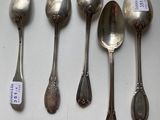 six silver spoons and a spoon with a price tag on them