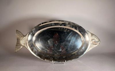 a silver plate with a fish on it on a table