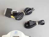 a nintendo wii game controller and a charger on a table