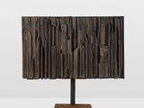 a close up of a wooden lamp on a metal stand