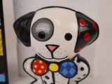 a dog figurine with a bow tie on it ' s neck