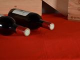 two bottles of wine sitting next to a wooden box