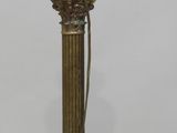 an antique brass lamp with a glass shade on top of it