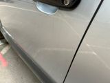 a close up of a car door handle on the side of the road