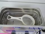 a metal container with a spoon in it on a counter