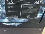 a hand that is holding a black box with a label on it