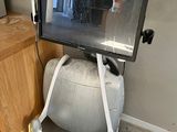 a television that is sitting on top of an exercise ball