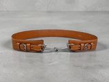 a close up of a tan leather belt with a metal buckle
