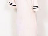 the mannequin is wearing a white dress with black stripes on it