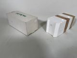 two boxes that are sitting next to each other on a table