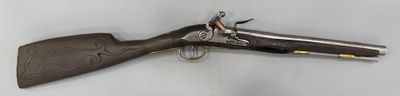un pistolet accroché au mur à côté d'une paire de ciseaux