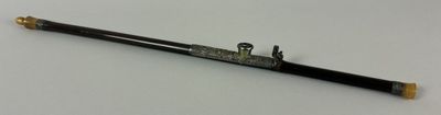 a black and gold pen sitting on top of a white table