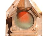 a small clock with a red light inside of it