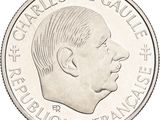 the back of a silver coin with a profile of a man ' s face
