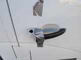 a close up of a door handle on a white car